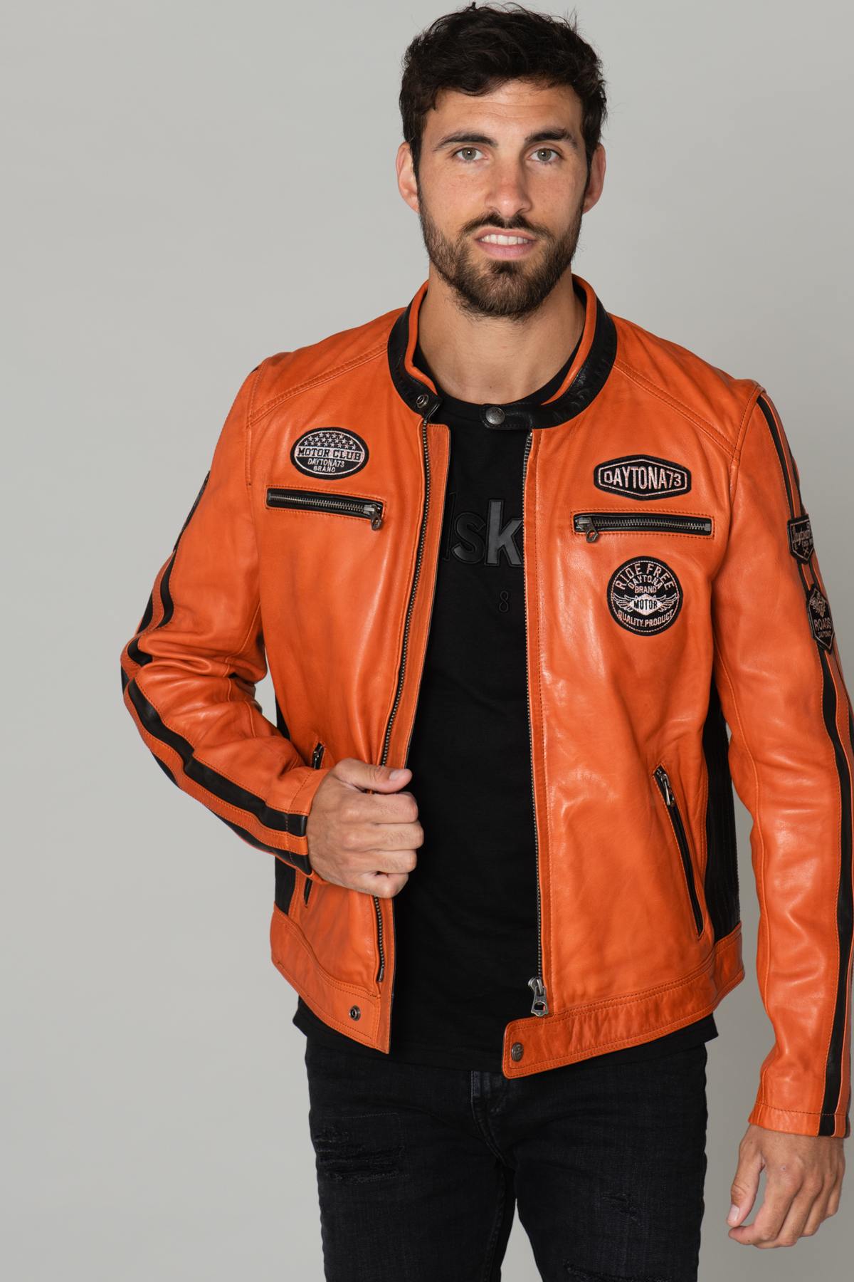 Orange and black leather biker jacket with patches - Image n°1