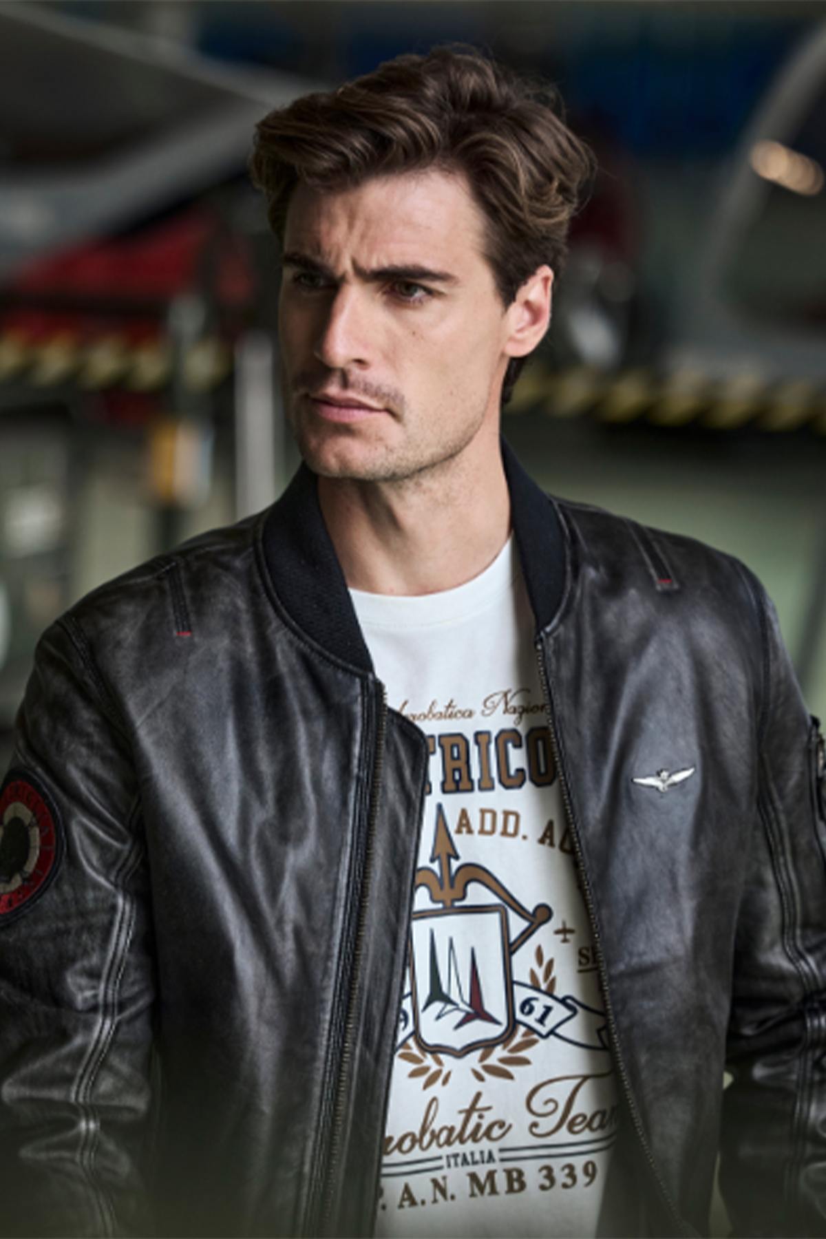 Black leather bomber jacket with sleeve patch - Image n°1