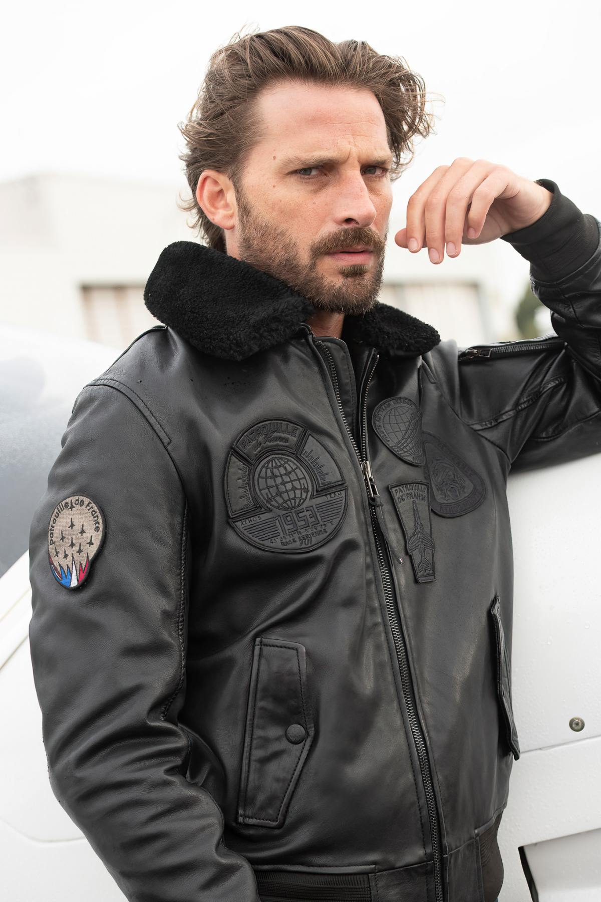 Men's black leather bomber jacket with black patches - Image n°1