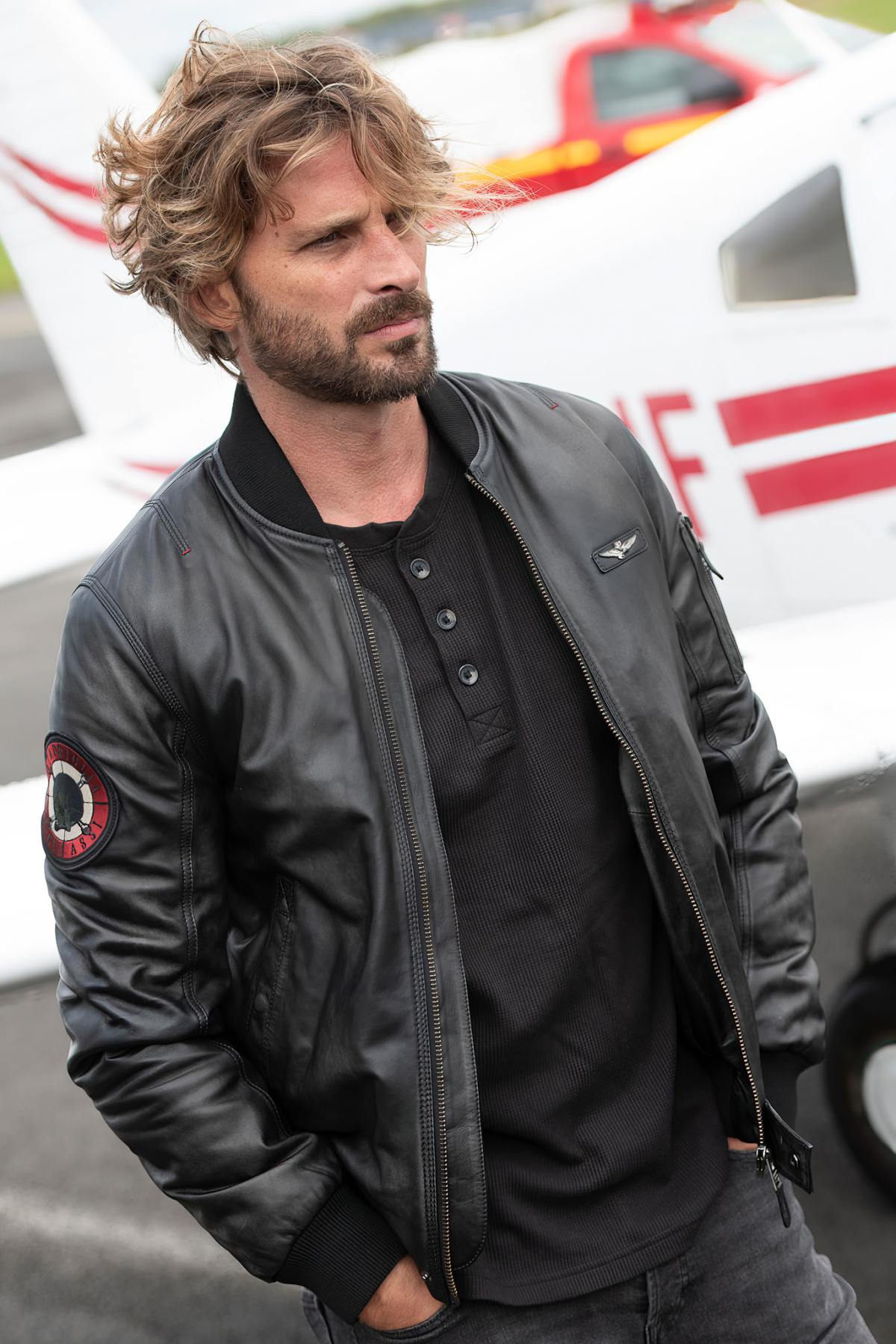 Black leather bomber jacket with sleeve patch - Image n°1