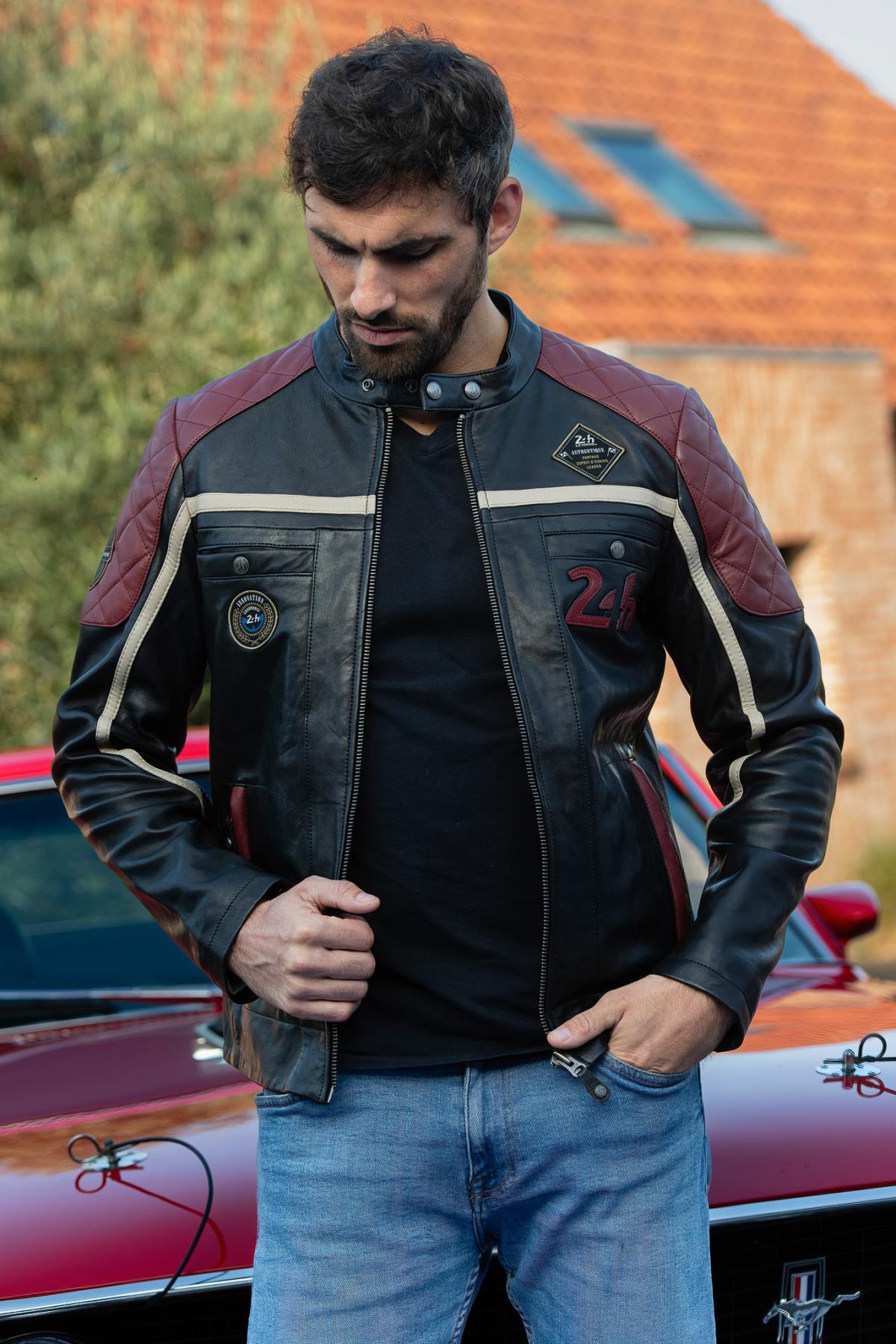 Black leather jacket with red inserts and quilted shoulders - Image n°1