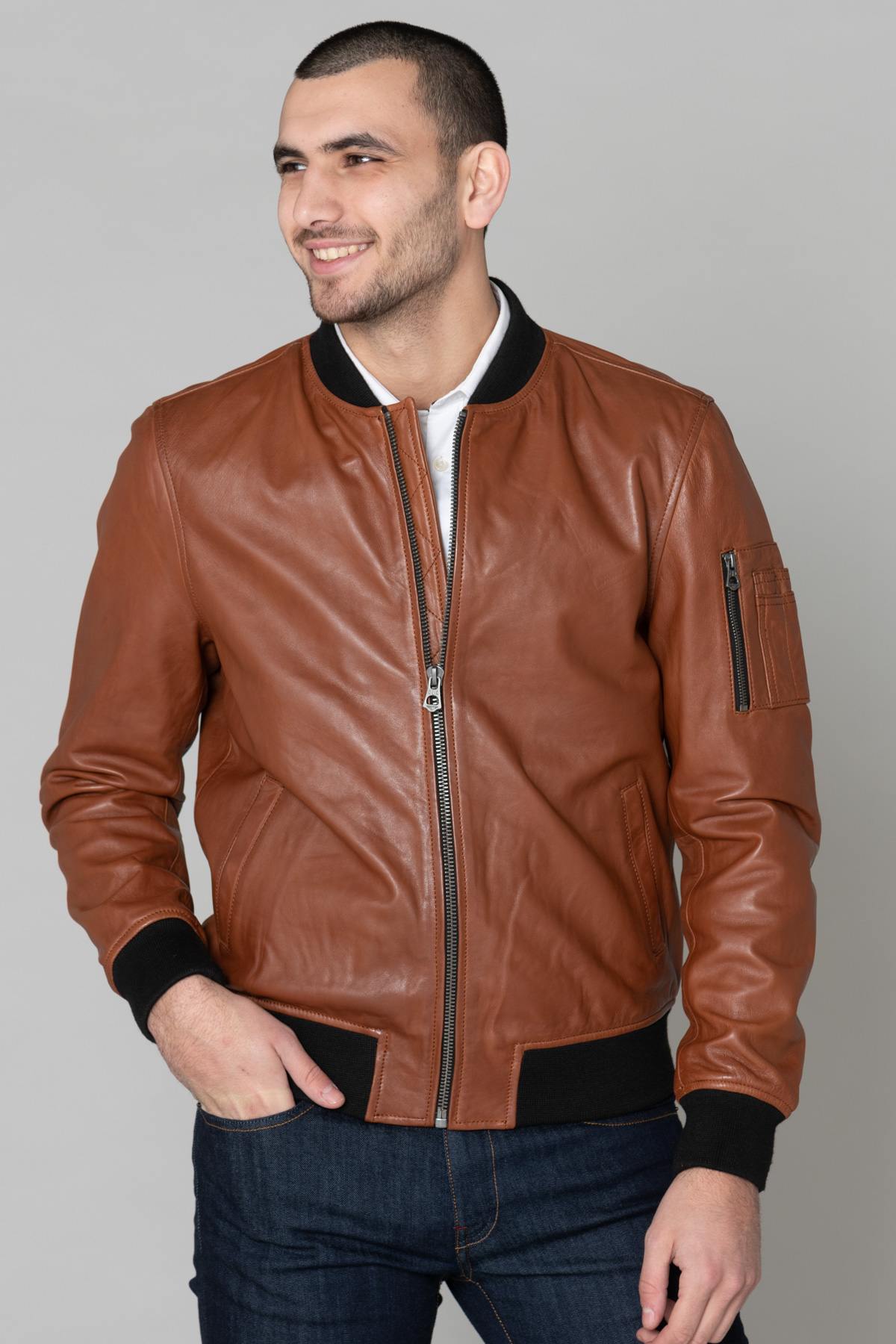 Bomber jacket in cognac leather and black ribbed edge - Image n°1